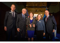 Senator Susan Collins posing with award alongside other attendees