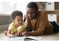 African American father and son reading together